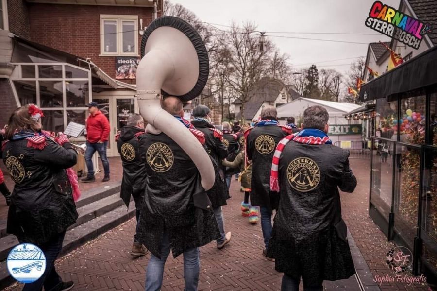 De Neutekrakers lopen spelend door Wijchen, met hun naam op de jassen